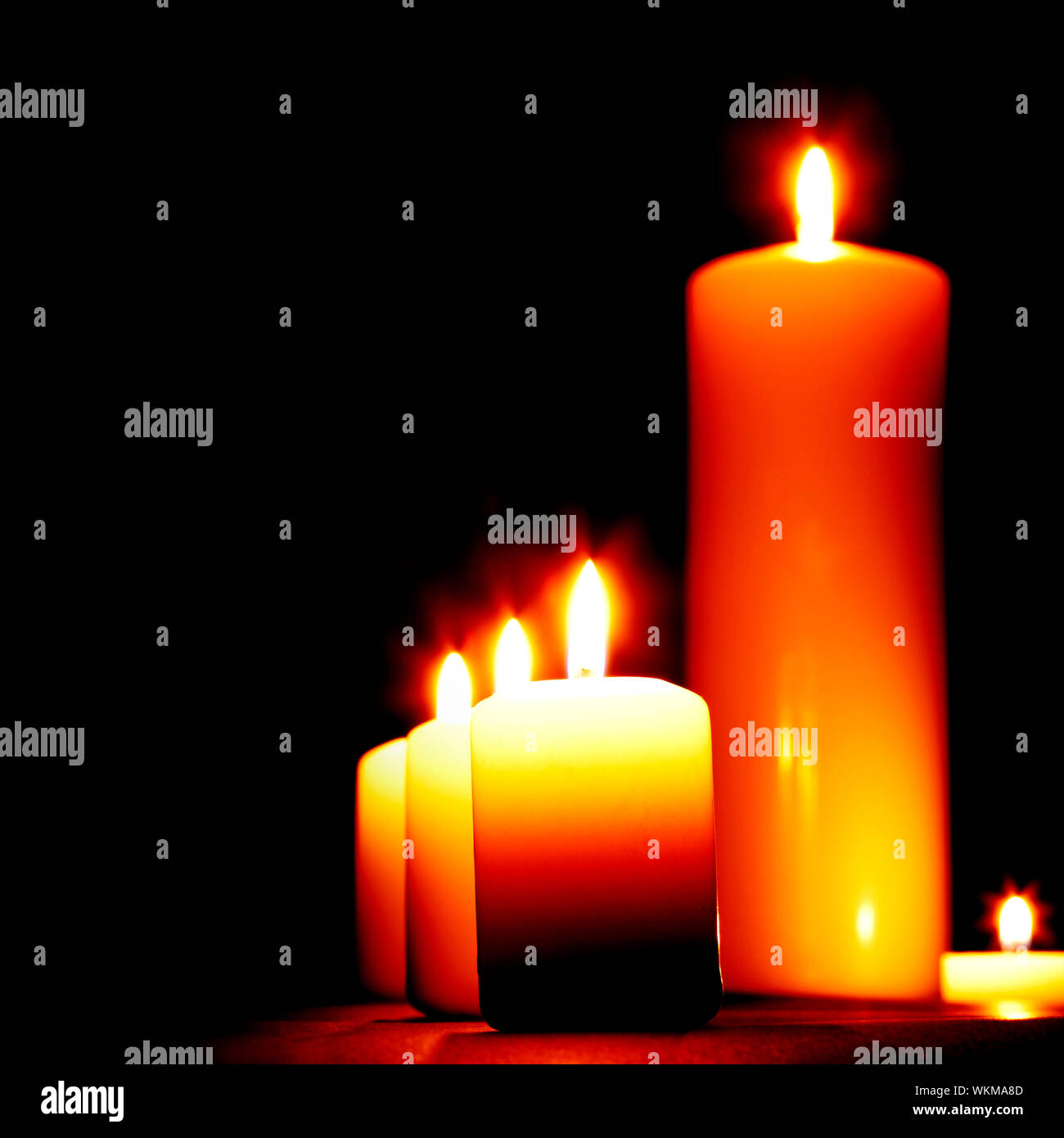 Set of lighting candles in a row on dark background Stock Photo - Alamy