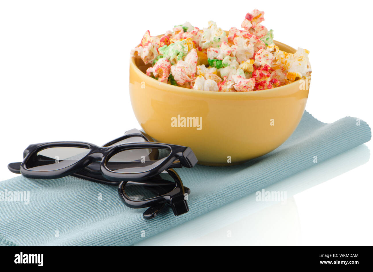 Bowl of popcorn and 3D movie glasses on white reflective background ...