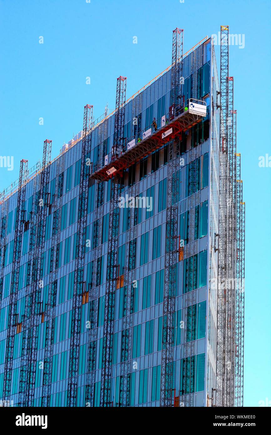 Completion of a glass facade on a modern high rise building hi-res ...
