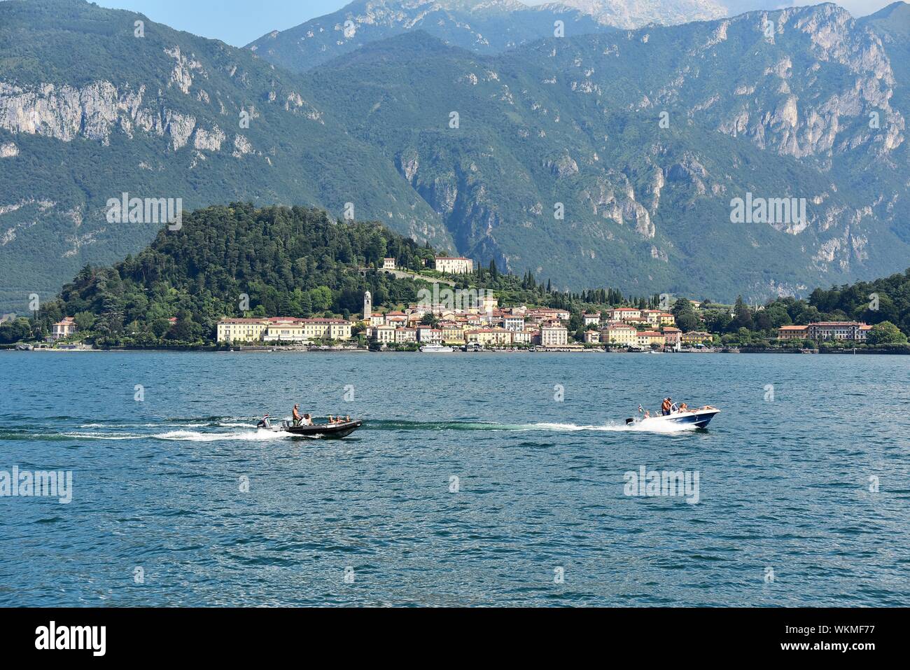 Motorboats on the Lago di Como, behind town Bellagio, Lombardy, Italy Stock Photo