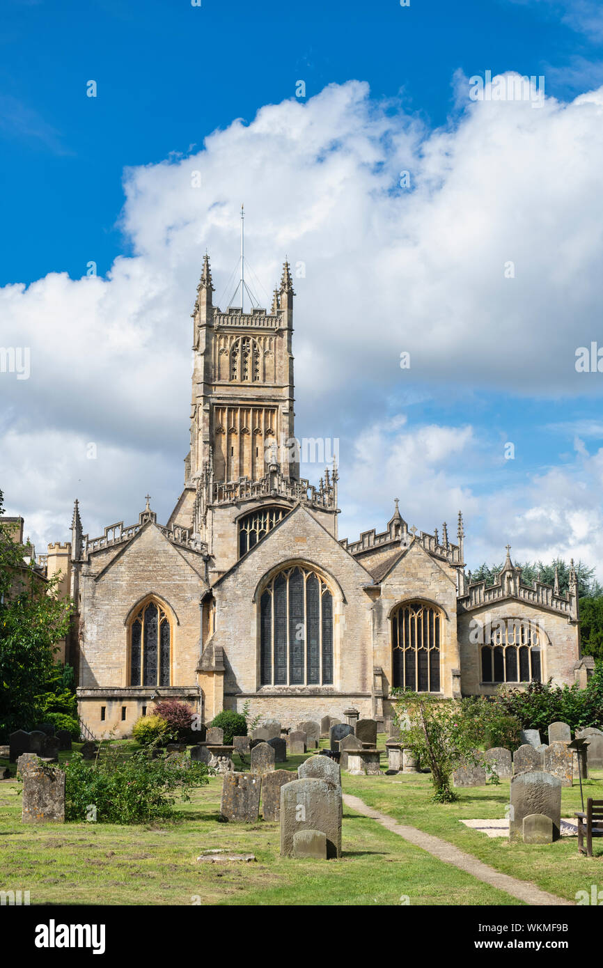 The Church of St. John the Baptist from the garden of rememberance. Cirencester, Cotswolds, Gloucestershire, England Stock Photo