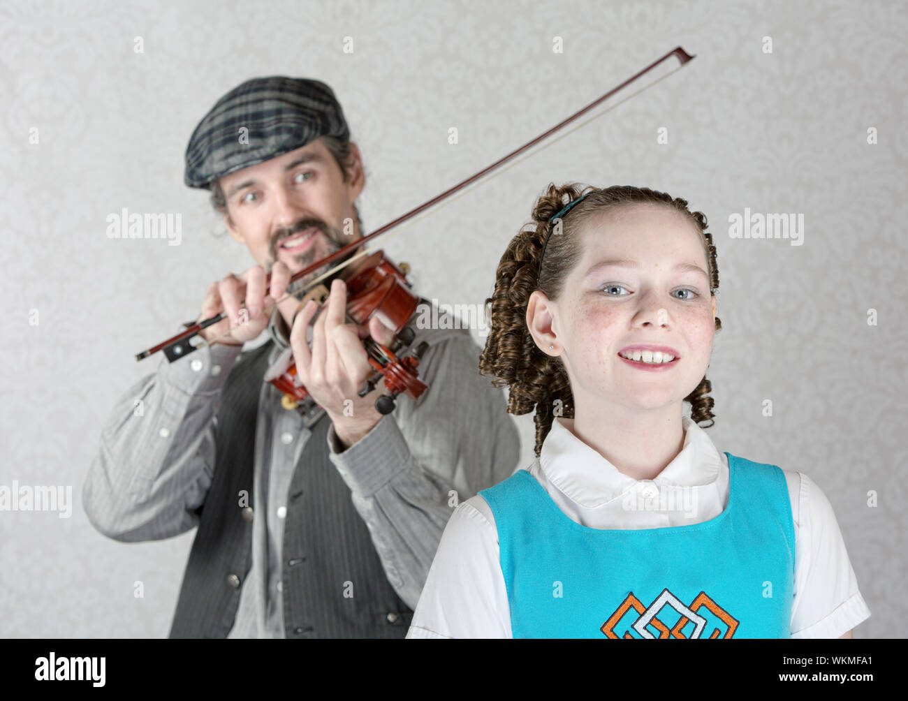 Cute Irish child listening to bearded man playing fiddle Stock Photo Alamy