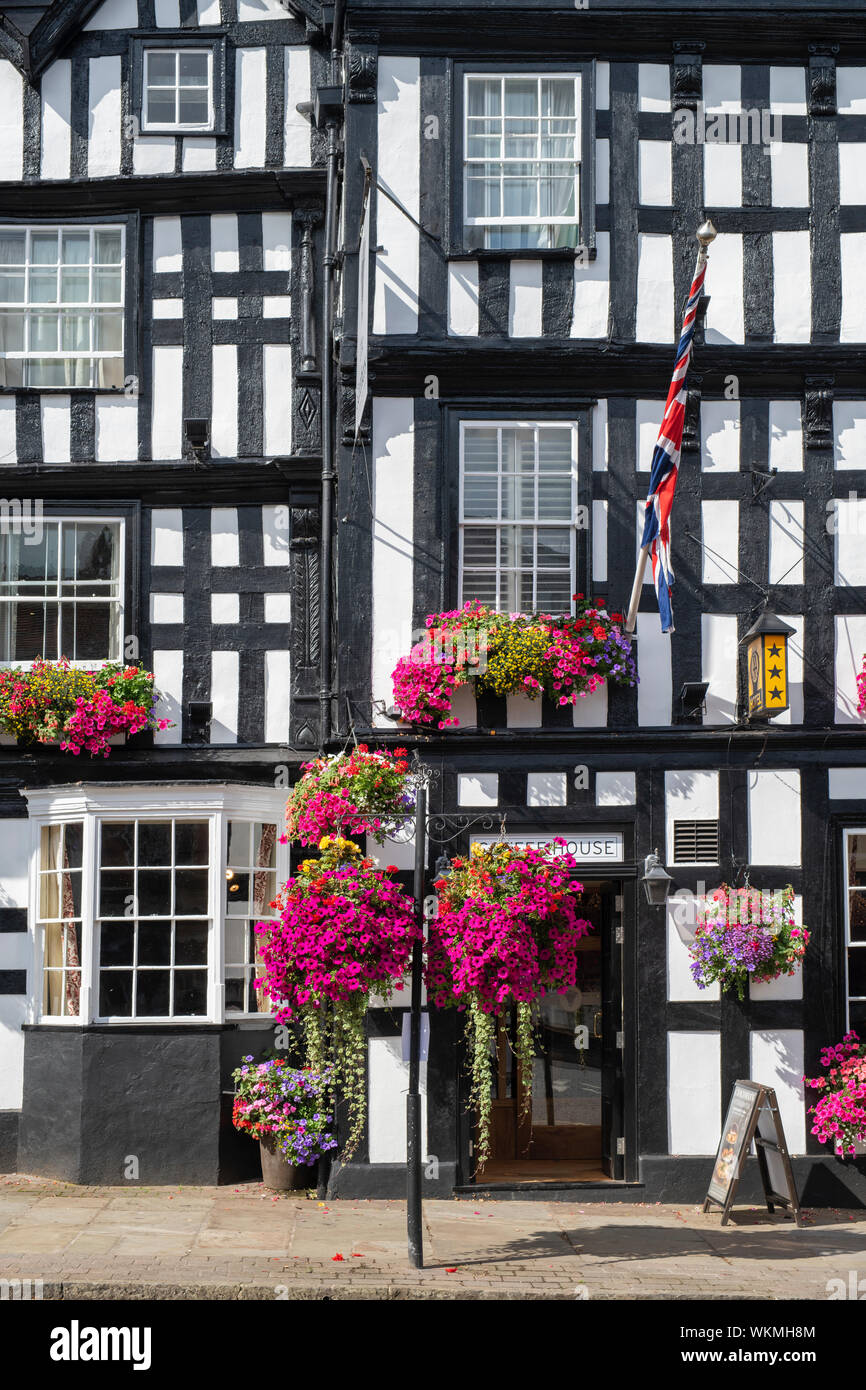 Floral hanging baskets and window boxes outside The Feathers hotel. 16th century timber framed period building, Ledbury Herefordshire. England Stock Photo