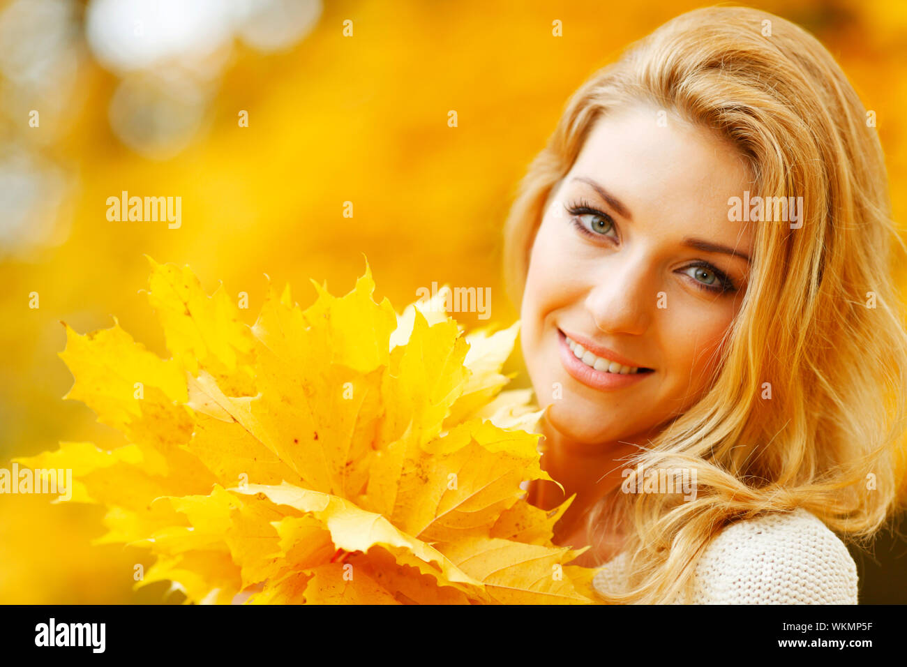 Portrait of a woman holding a maple leaf hi-res stock photography and ...