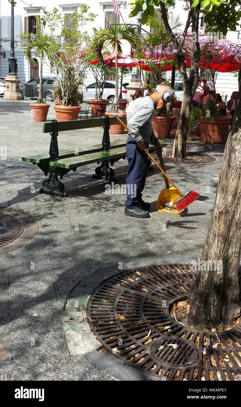 Man sweeping street hires stock photography and images Alamy
