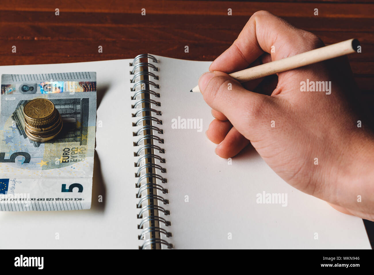 Male Hand Writing Close To European Currency Stock Photo