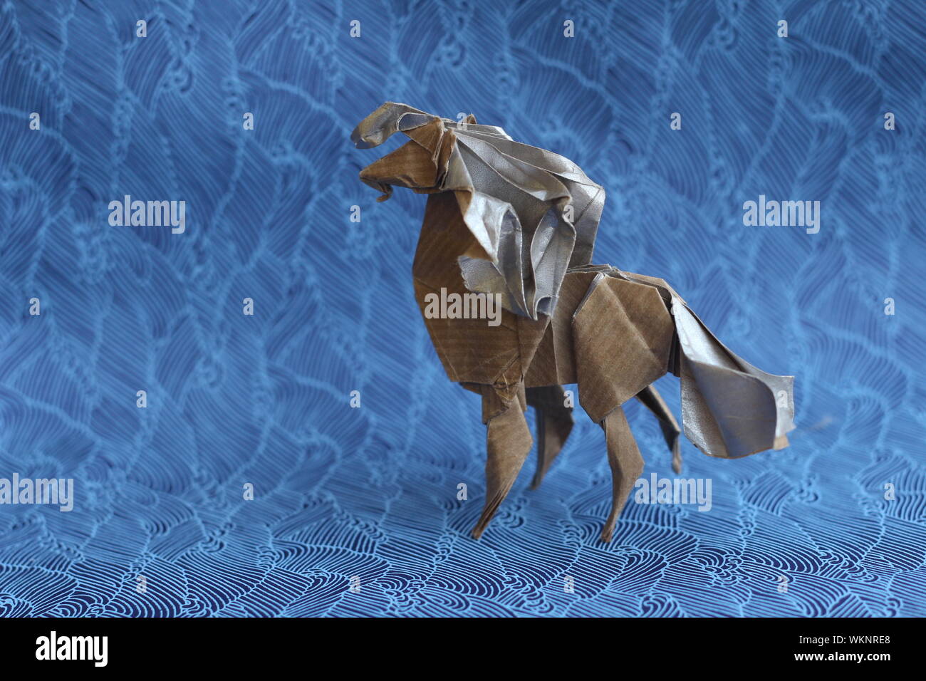 Close-up Of Paper Horse On Blue Backdrop Stock Photo