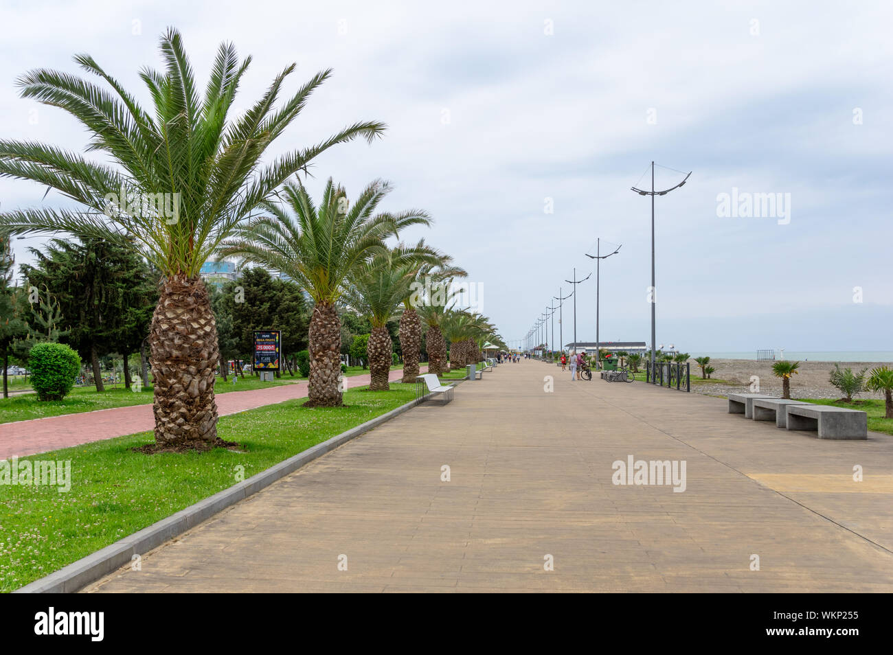 Seaside promedane in Batumi, Georgia, with red-painted bike lane and wide pedestrian street for vacationers Stock Photo