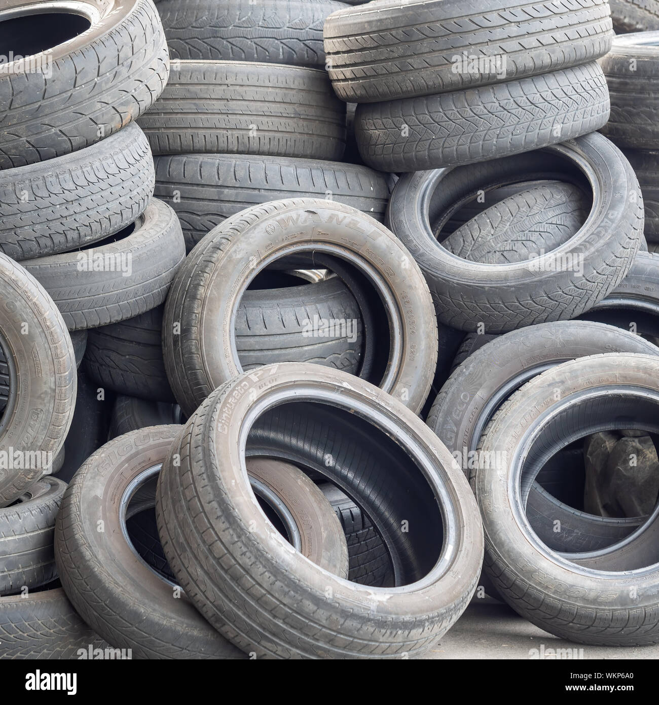 AULLA, MASSA CARRARA, ITALY - AUGUST 28, 2019: Old car and vehicle tyres, tires wait to be disposed of. Closeup detail. Stock Photo