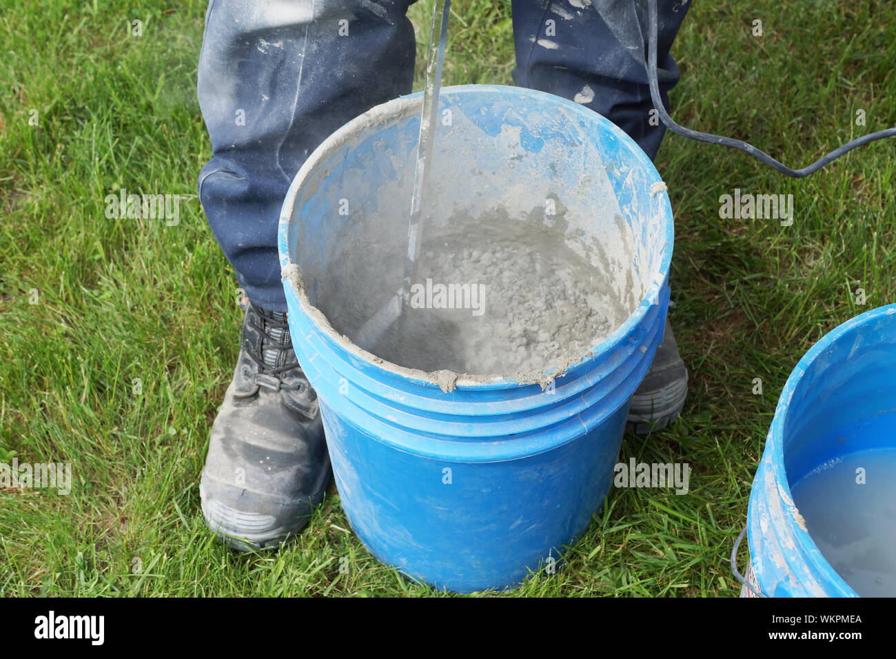 Man mixing cement with drill outside Stock Photo Alamy