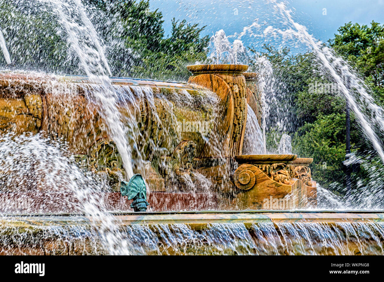 Water is spraying from Buckingham Fountain in Grant Park. Streets of Chicago. Stock Photo