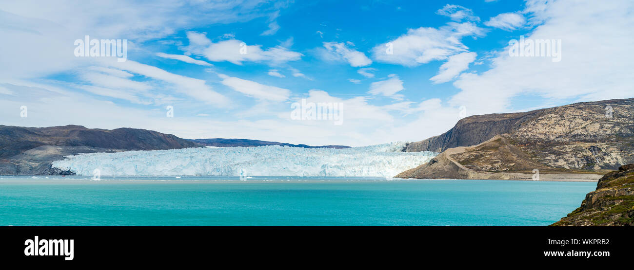Panoramic view of glacier in Greenland. Glacier front of Eqi glacier in West Greenland AKA Ilulissat and Jakobshavn Glacier. Heavlly affected by Climate Change and Global Warming. Stock Photo