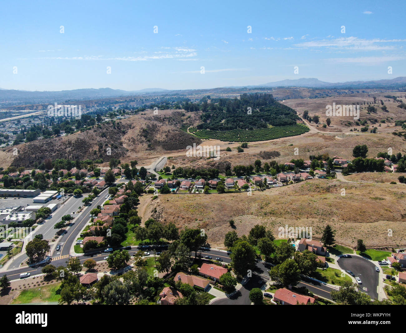 Aerial view of small neighborhood with dry desert mountain on the background in Moorpark, Ventura County in Southern California. USA Stock Photo