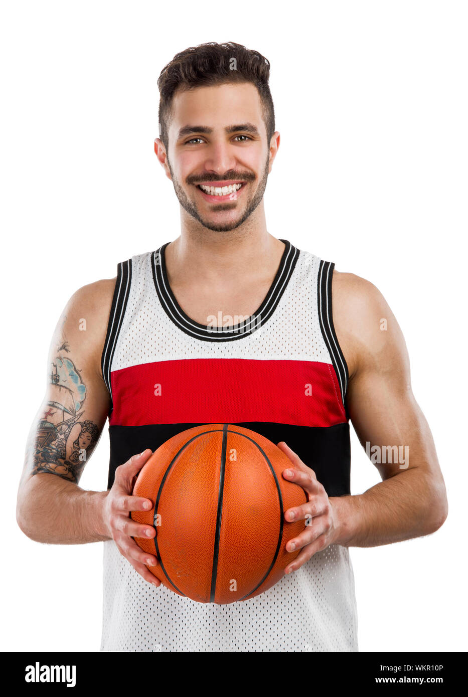 Athletic man holding a basket ball and smiling, isolated over a white