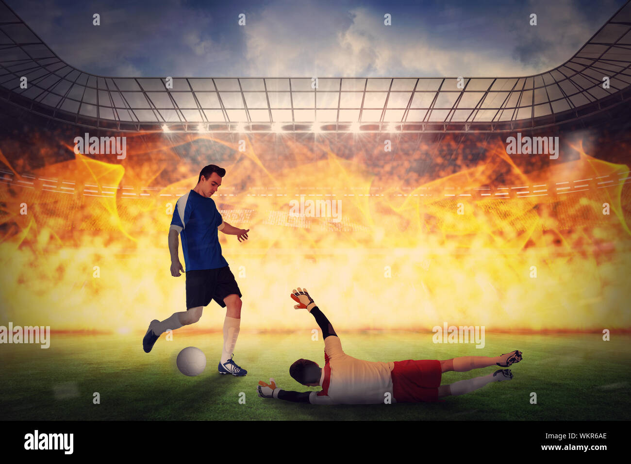 Football players tackling for the ball against large football stadium