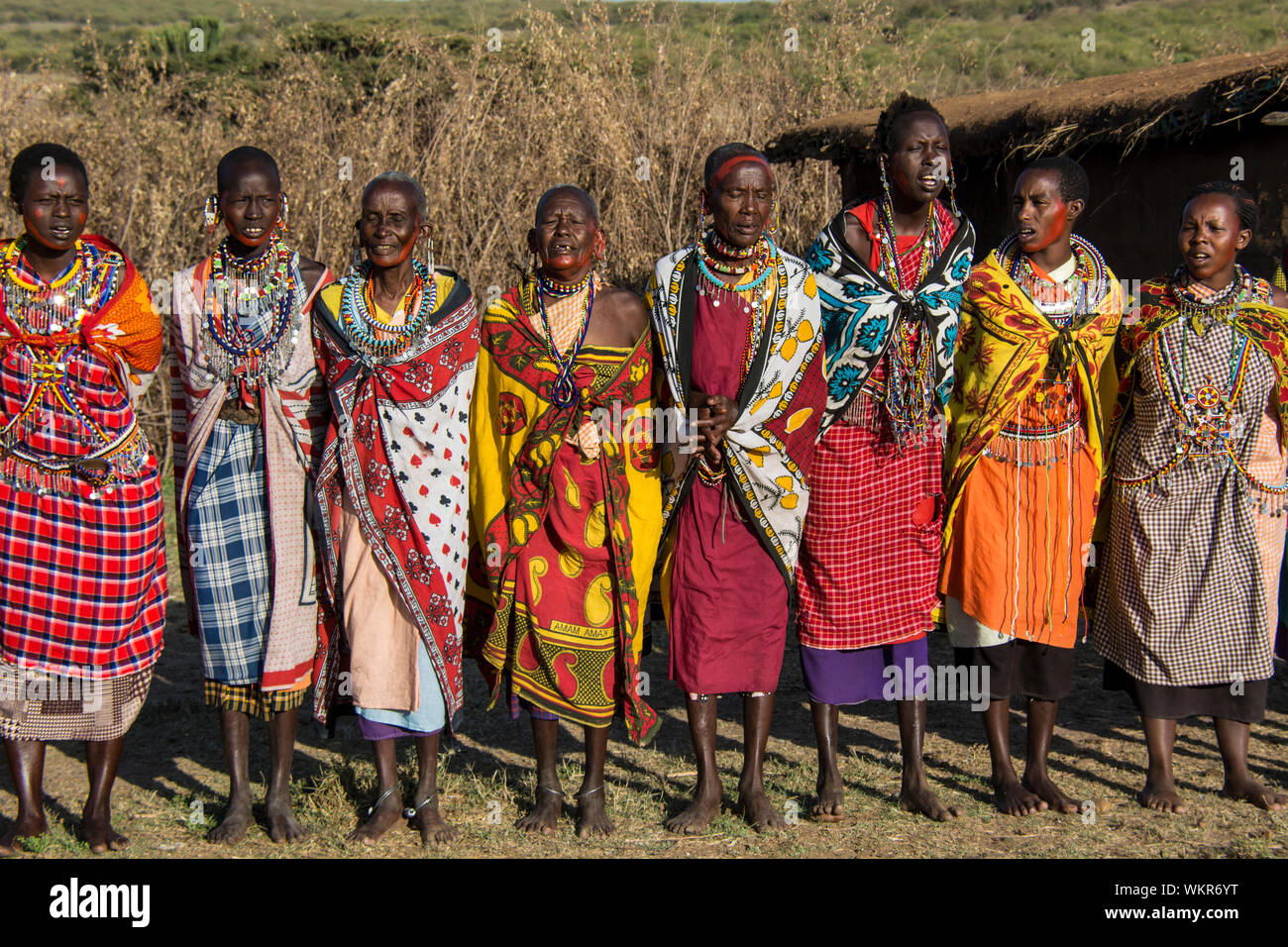 Group of Maasai Women wearing traditional kangas, village near the Masai Mara, Kenya, East Africa Stock Photo