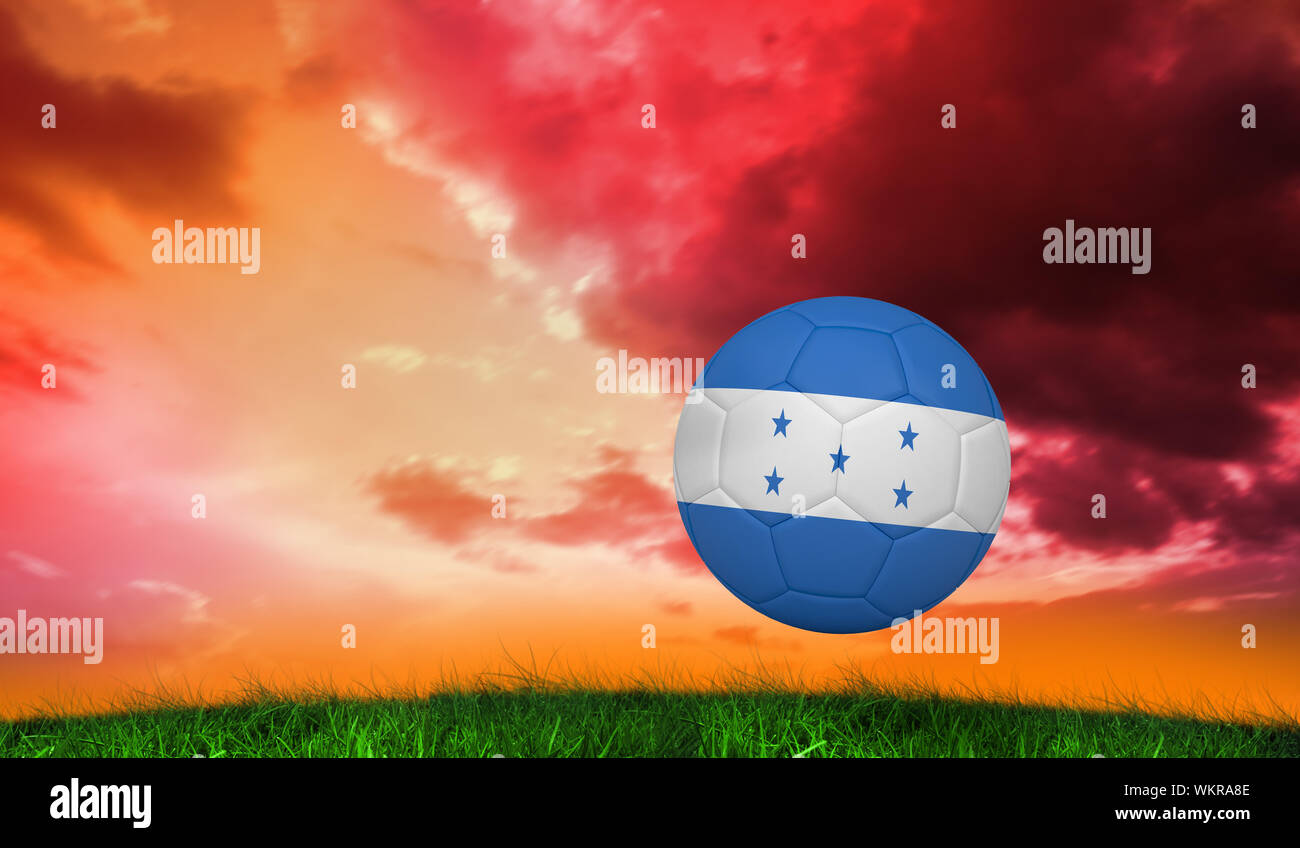 Football in honduras colours against green grass under red and purple