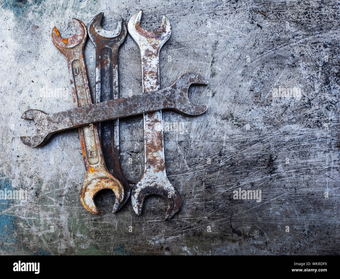 Directly Above Shot Of Rusty Wrenches On Scratched Metal Table Stock Photo
