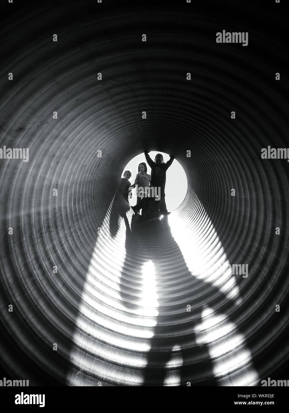 Children Playing In Tunnel Slide At Playground Stock Photo Alamy
