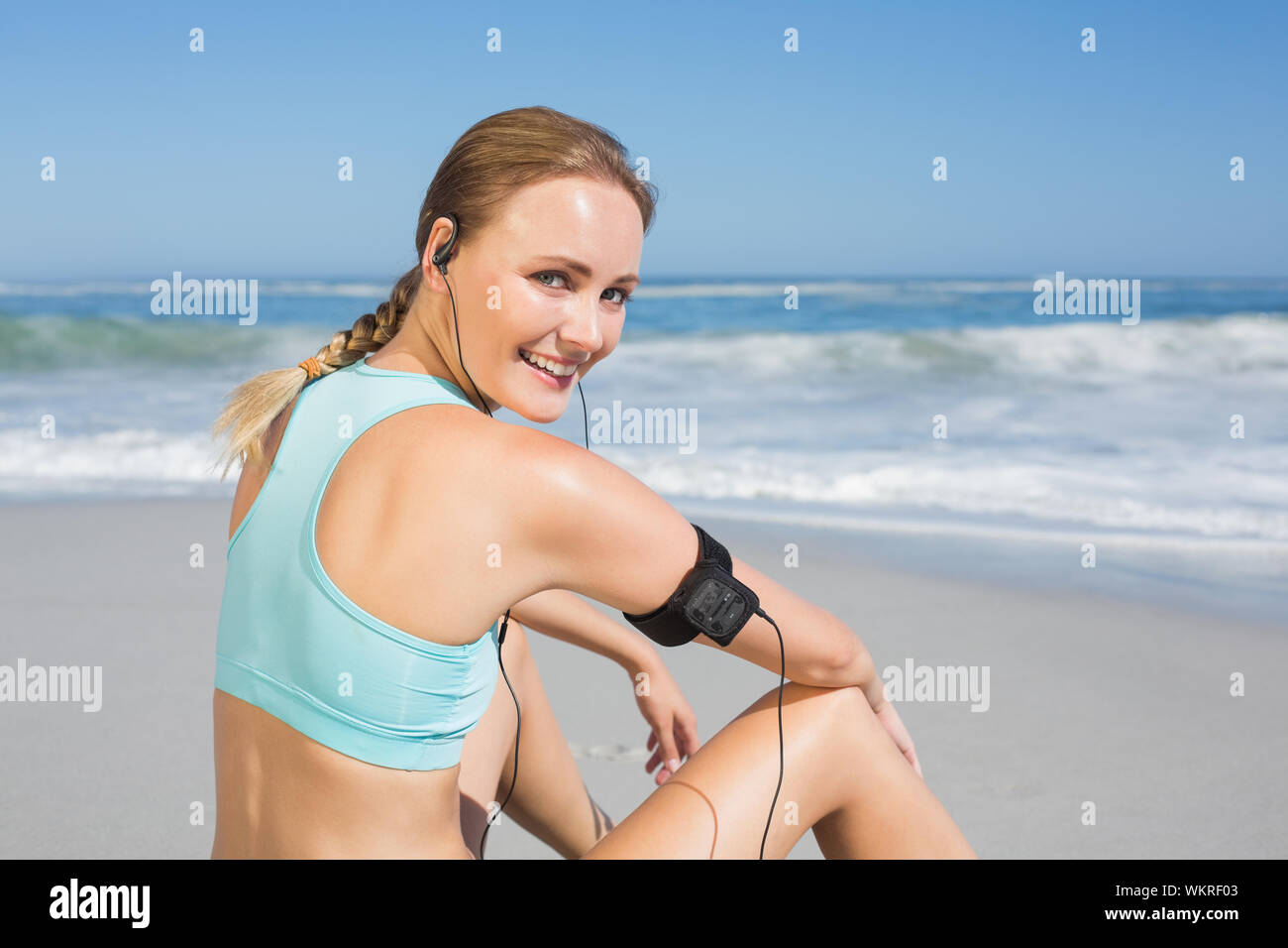 Woman Taking Off Her Bra Backwards Towards The Camera Stock Photo
