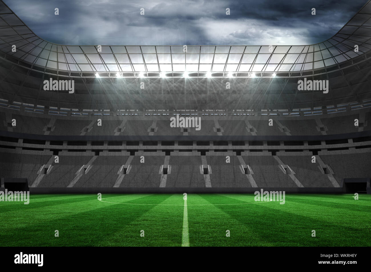 Digitally generated large empty football stadium under clouds Stock