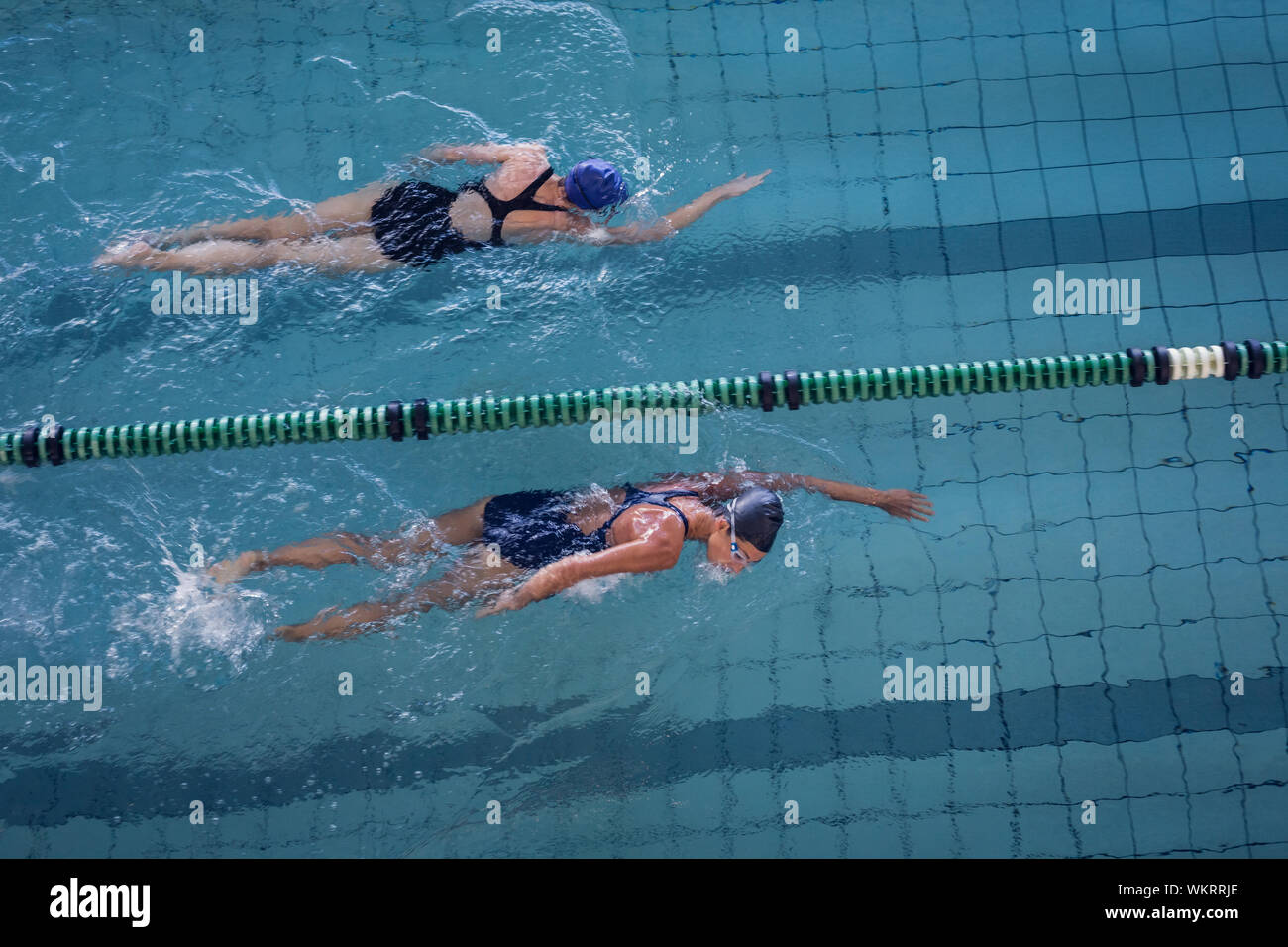 Female swimmers racing in the swimming pool at the leisure center Stock ...