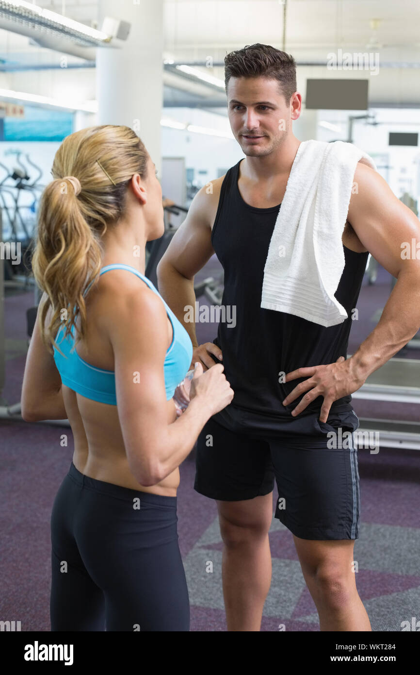 Bodybuilding man and woman talking together at the gym Stock Photo - Alamy