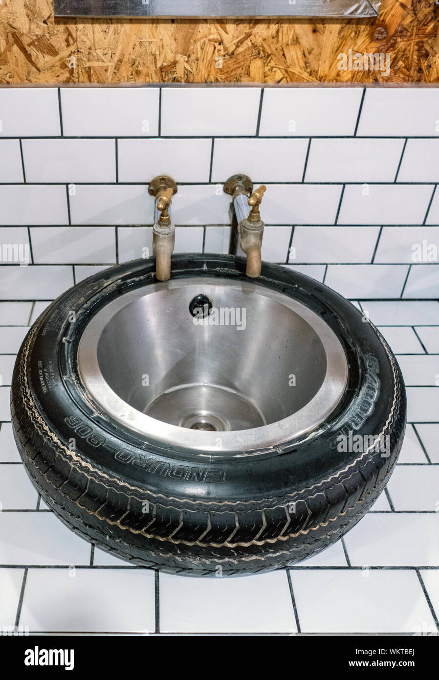 Novelty rubber car tyre and stainless steel bowl sink in public mens