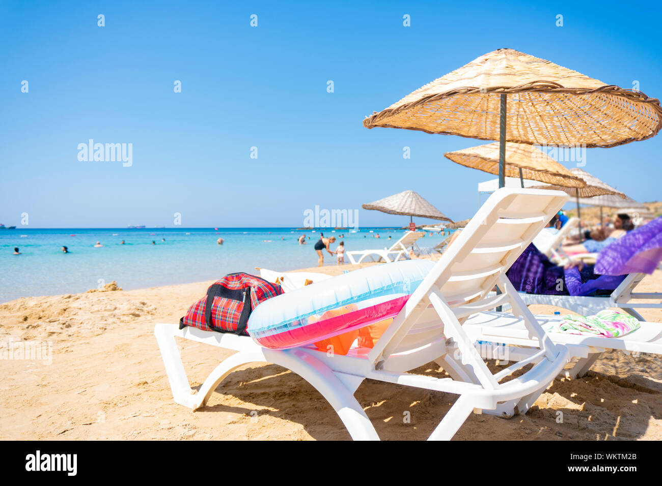 Sunbath on the beach with people Stock Photo