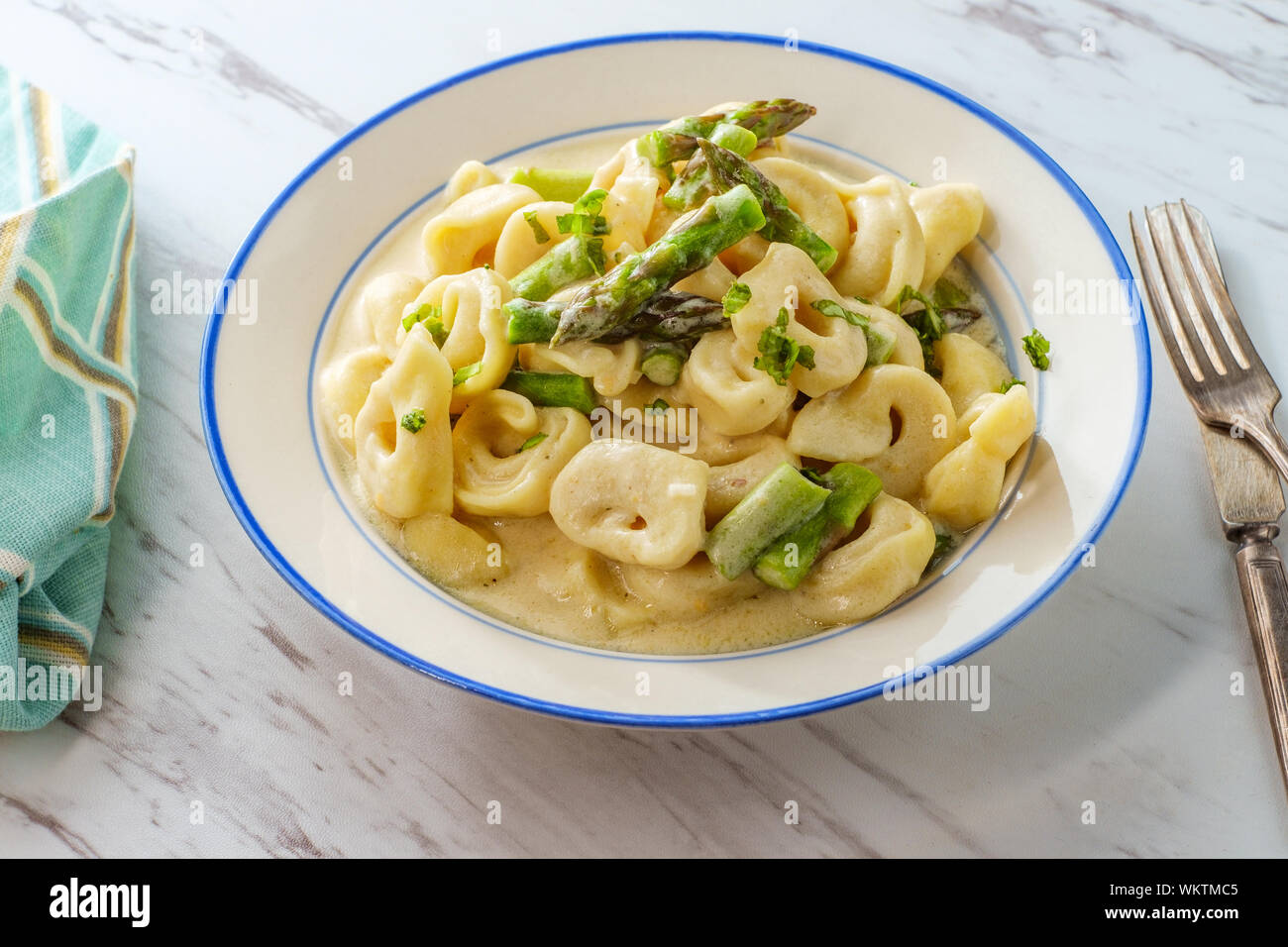Italian butter and parmesan cheese tortellini alfredo with asparagus Stock Photo Alamy