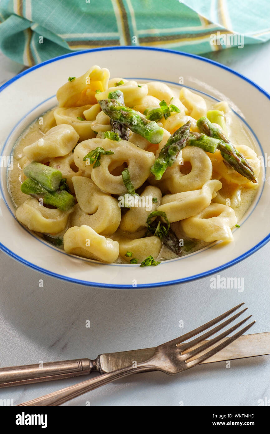 Italian butter and parmesan cheese tortellini alfredo with asparagus Stock Photo Alamy