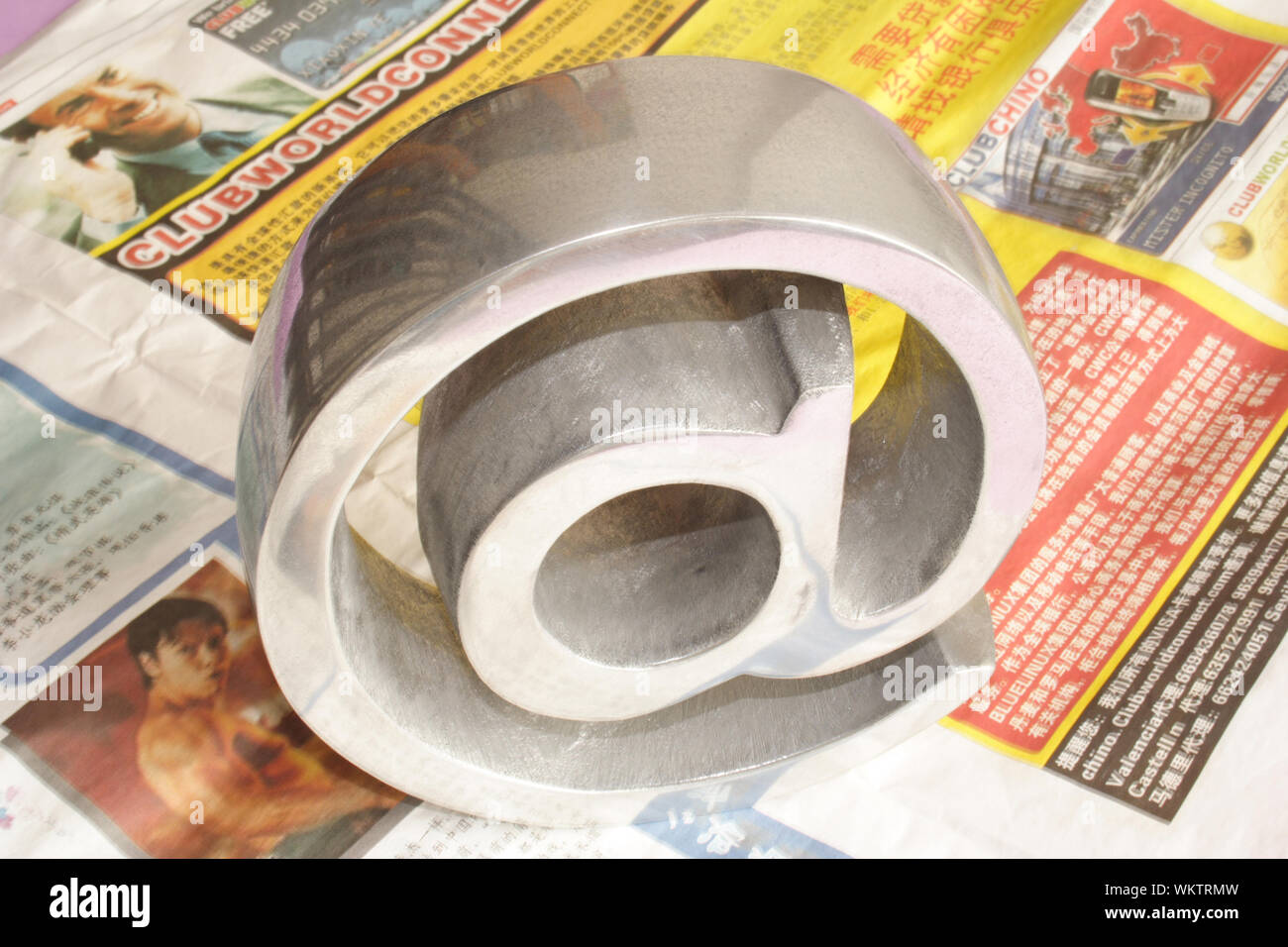 Grey symbol on top of several oriental newspapers Stock Photo - Alamy