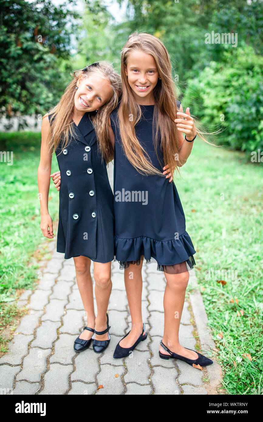 Two Cute Smiling Little Girls Posing In School Adorable Little Kids Feeling Very Excited About Going Back To School Stock Photo Alamy