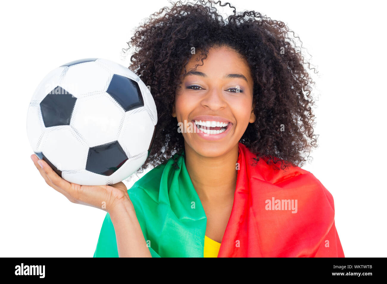 Pretty football fan with portugal flag holding ball on white background Stock Photo