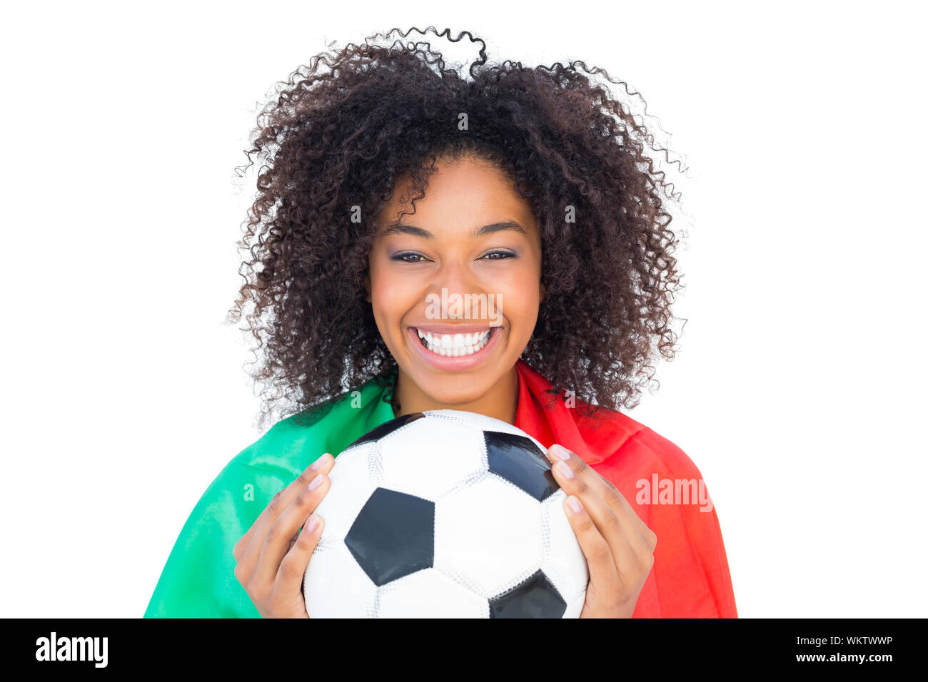 Pretty football fan with portugal flag holding ball on white background Stock Photo