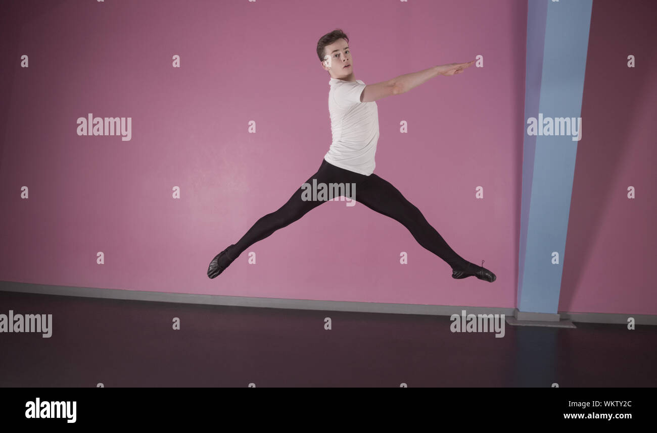 Focused male ballet dancer leaping in the dance studio Stock Photo Alamy