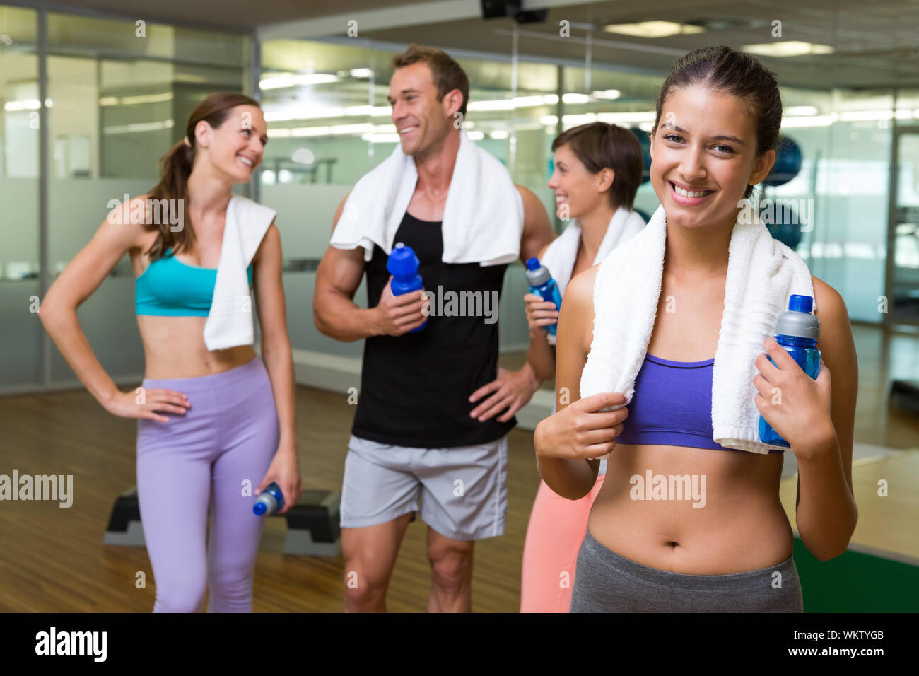 Fit woman smiling at camera in busy fitness studio at the gym Stock ...