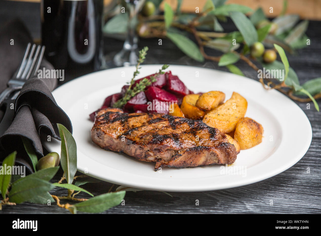 Steak Dinner with potatoes on white plates Stock Photo Alamy