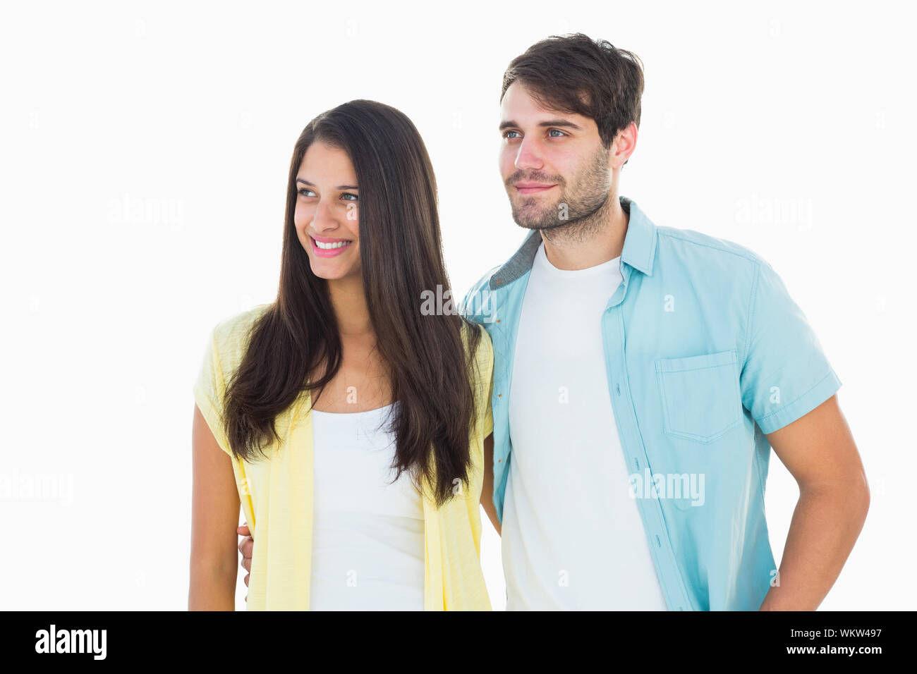 Happy casual couple smiling together on white background Stock Photo ...