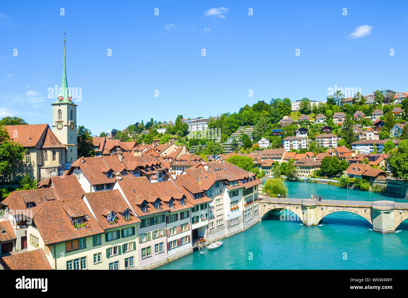 Bern, the capital of Switzerland, with dominant Nydegg Church and historical center located along turquoise Aare River. Bridge over Aare. Tourist destination, local attraction. Swiss city. Stock Photo