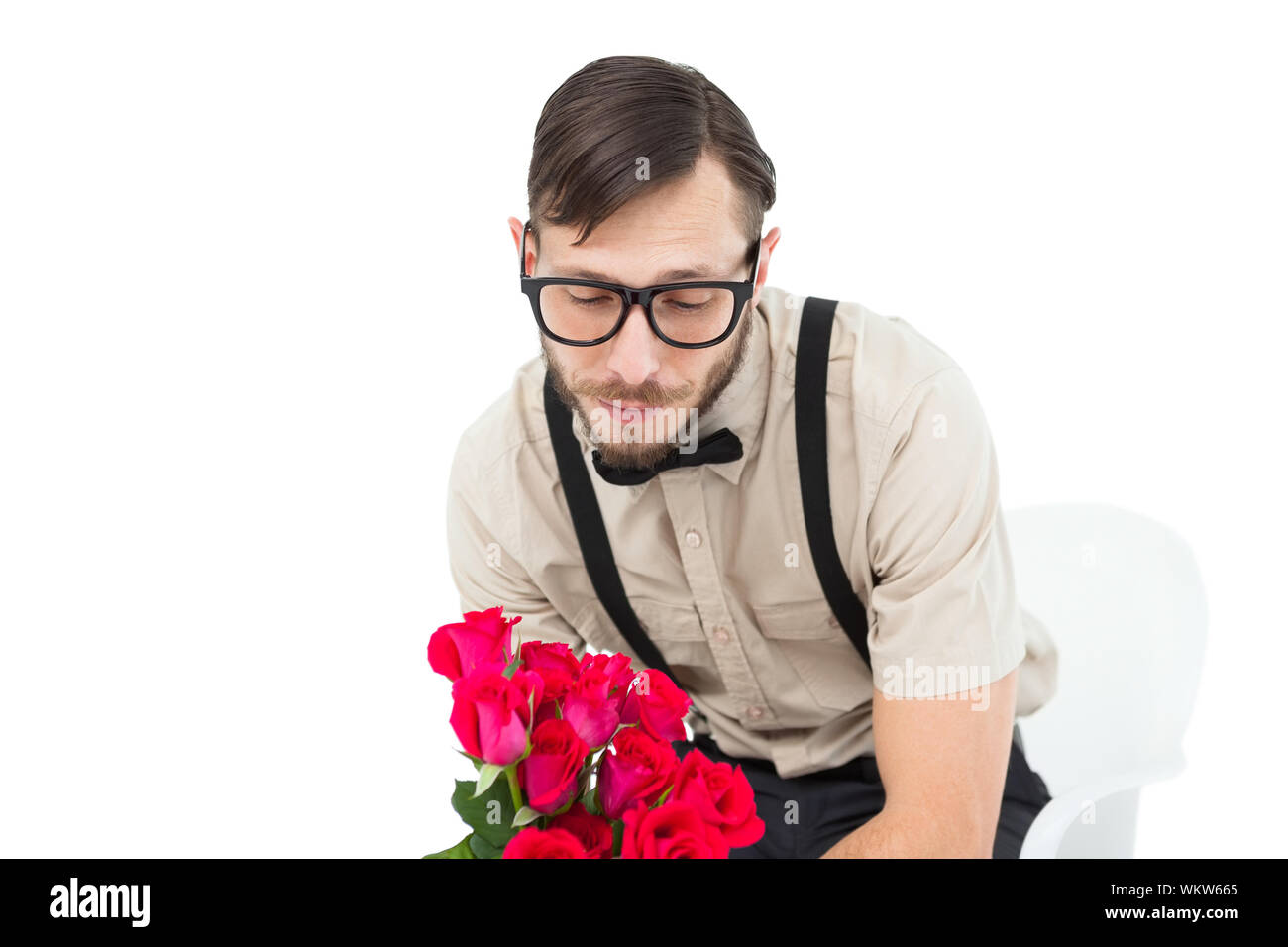 Geeky heartbroken hipster holding roses on white background Stock Photo ...