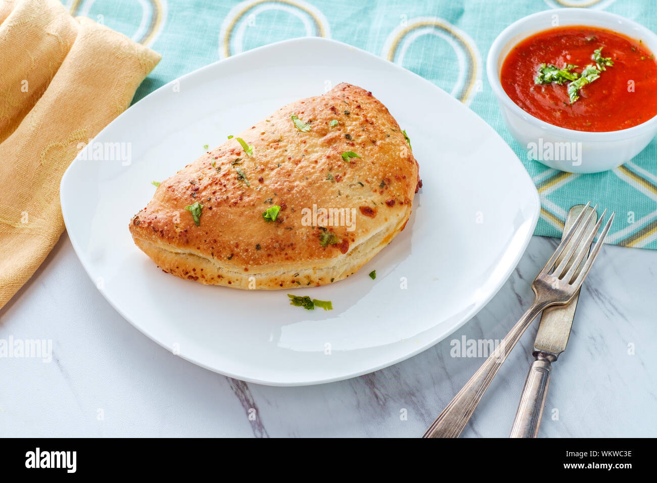 Italian pastry pepperoni and cheese calzone with tomato marinara