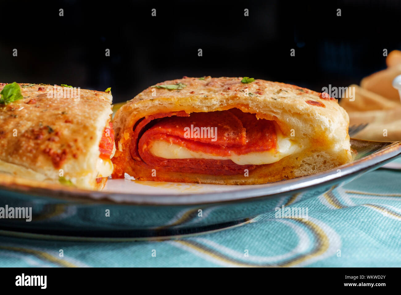 Italian pastry pepperoni and cheese calzone with tomato marinara