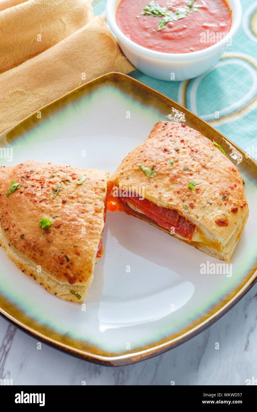 Italian pastry pepperoni and cheese calzone with tomato marinara