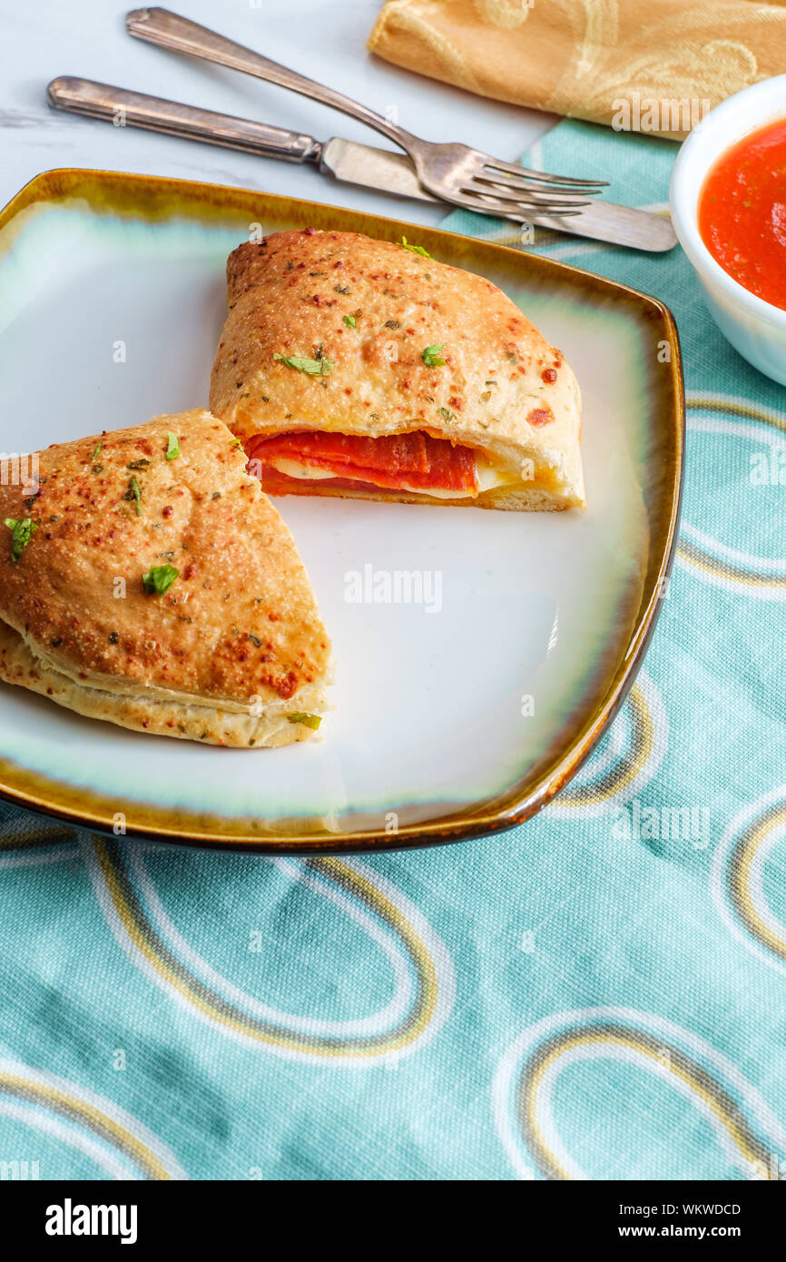 Italian pastry pepperoni and cheese calzone with tomato marinara