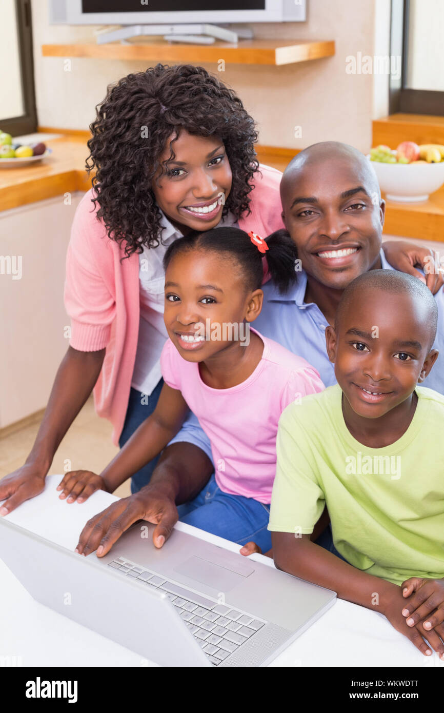 Happy family using the laptop together at home in the kitchen Stock ...