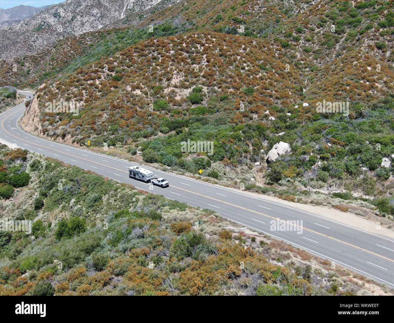 Asphalt road bends through Angeles National forests mountain ...