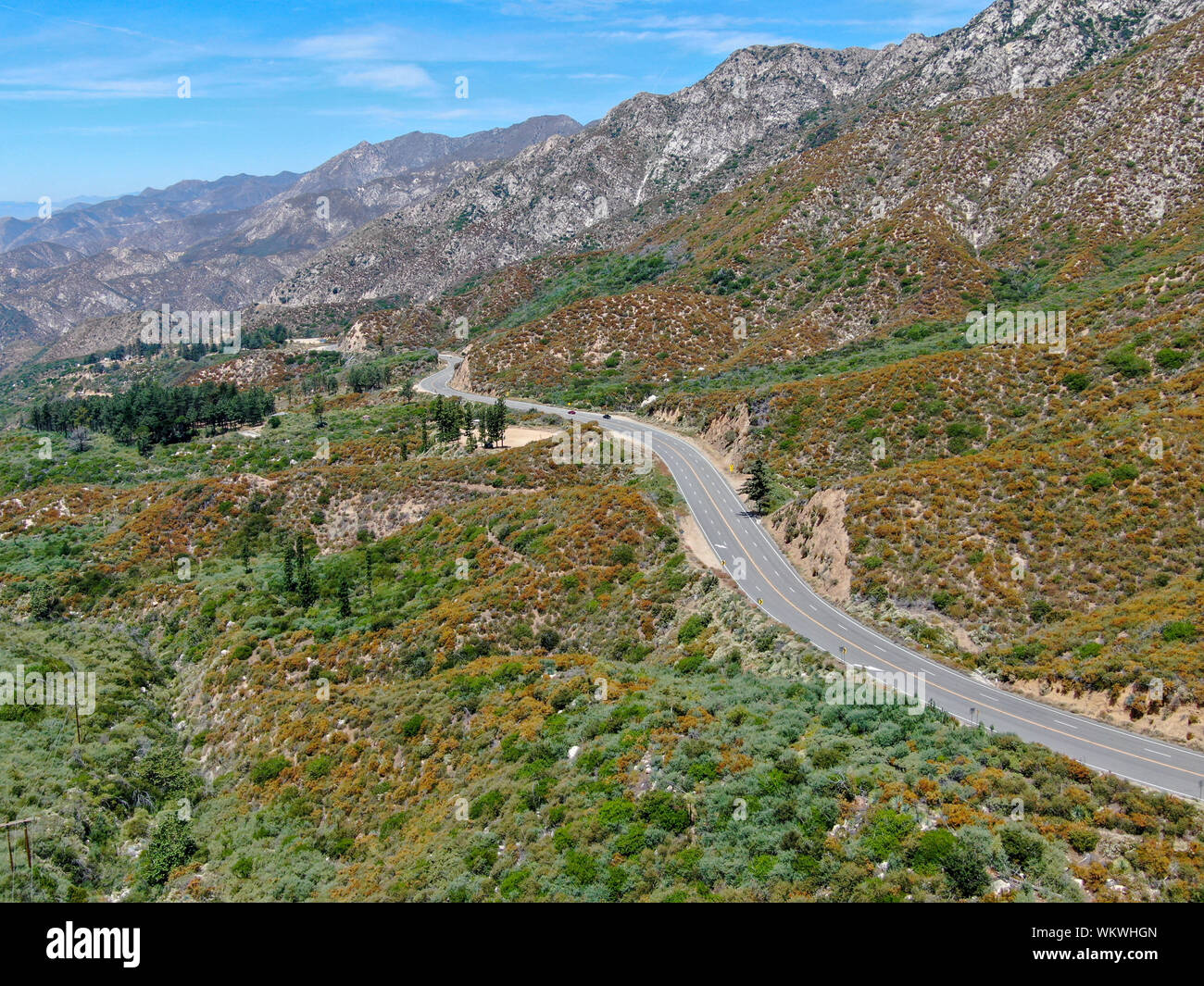 Asphalt road bends through Angeles National forests mountain ...
