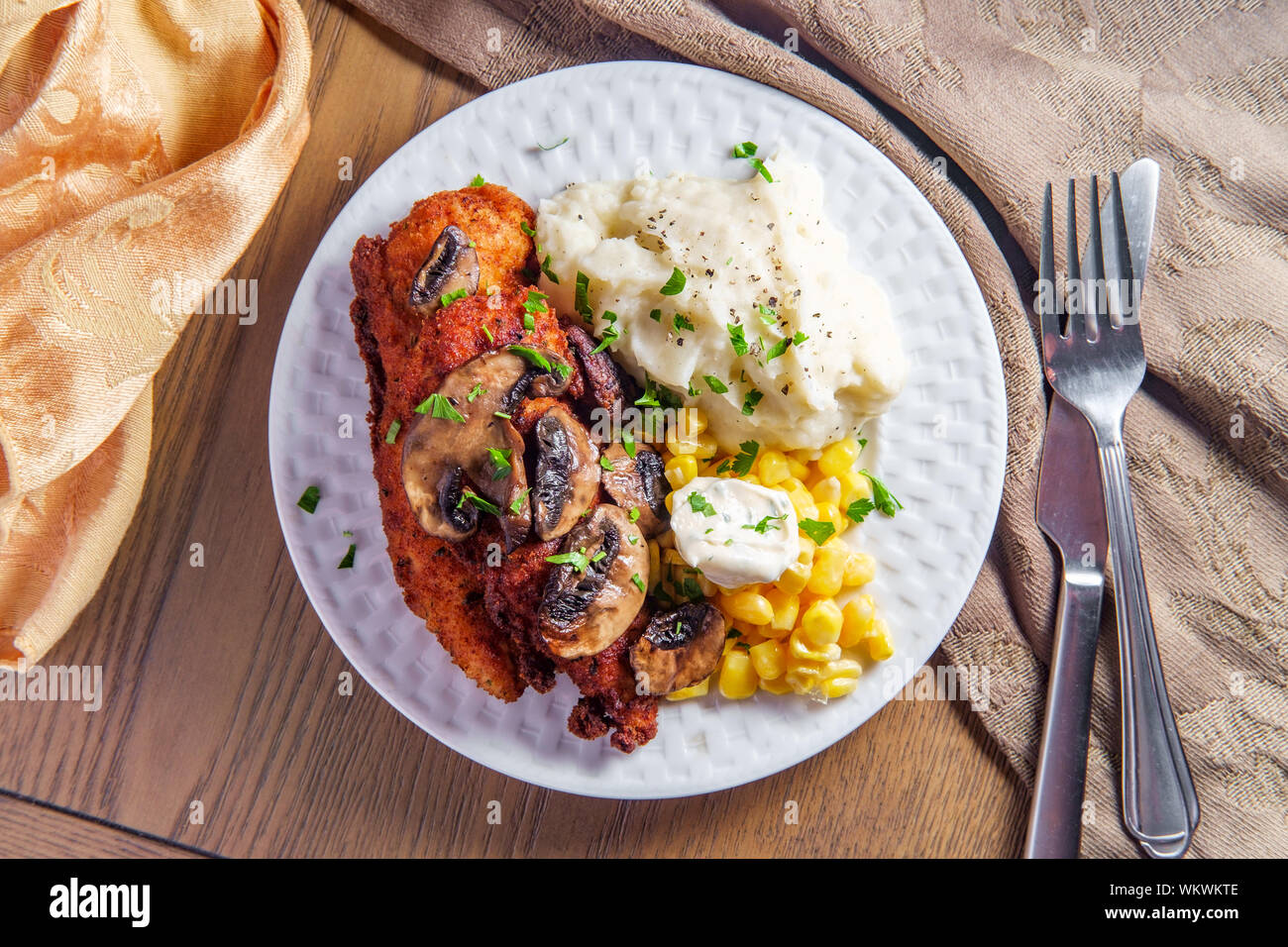 Crispy breaded chicken marsala with mashed potatoes and kernel corn