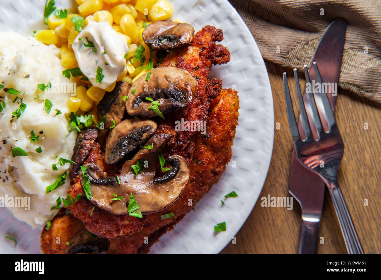 Crispy breaded chicken marsala with mashed potatoes and kernel corn